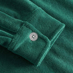 Close up on sleeve on a green kaftan in terry toweling fabric.